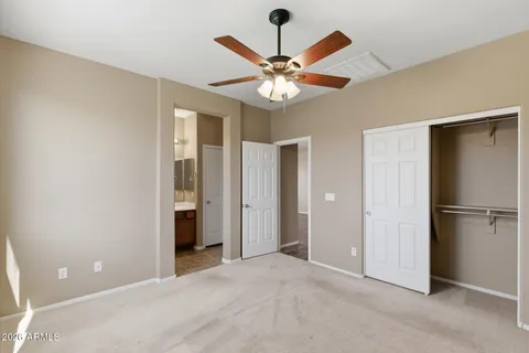 a view of a livingroom with a ceiling fan window and closet