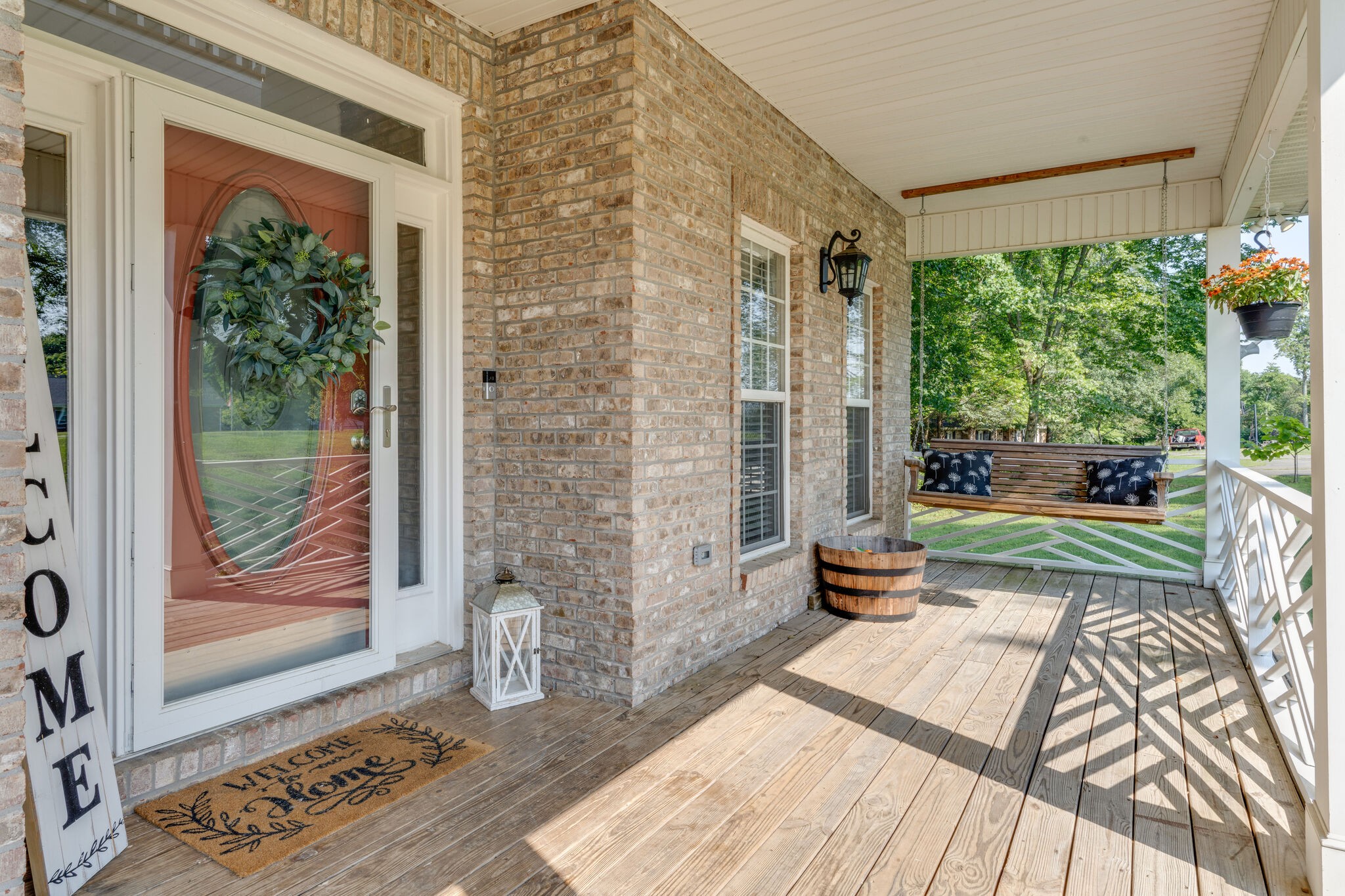 2754 Gideon Road Greenbrier, TN 37073 - Photo 4 of 45 a bench is sitting in front of a brick house with a floor to ceiling window