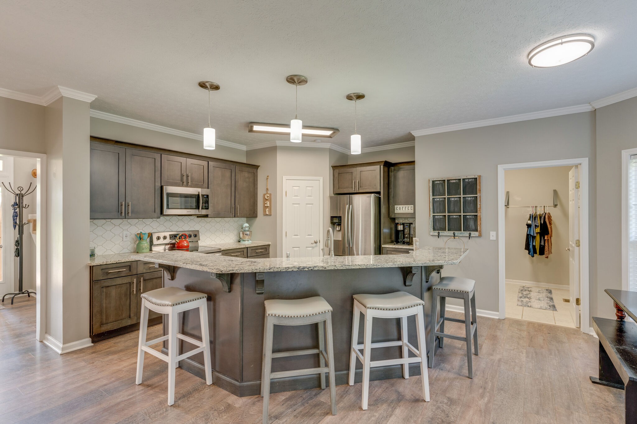 2754 Gideon Road Greenbrier, TN 37073 - Photo 10 of 45 a kitchen with stainless steel appliances a dining table chairs refrigerator and sink