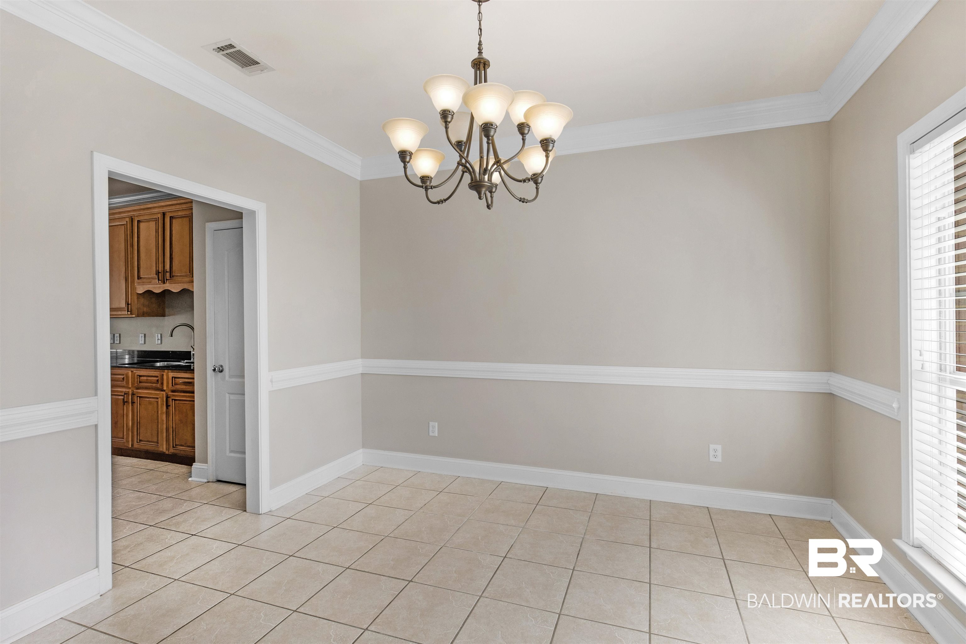 330 Allison Court Mobile, AL 36608 - Photo 11 of 27 Tiled spare room with ornamental molding, sink, and a notable chandelier