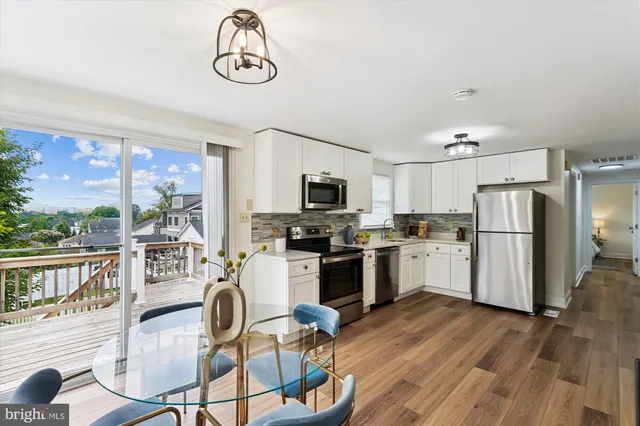 a kitchen with refrigerator cabinets dining table and chairs