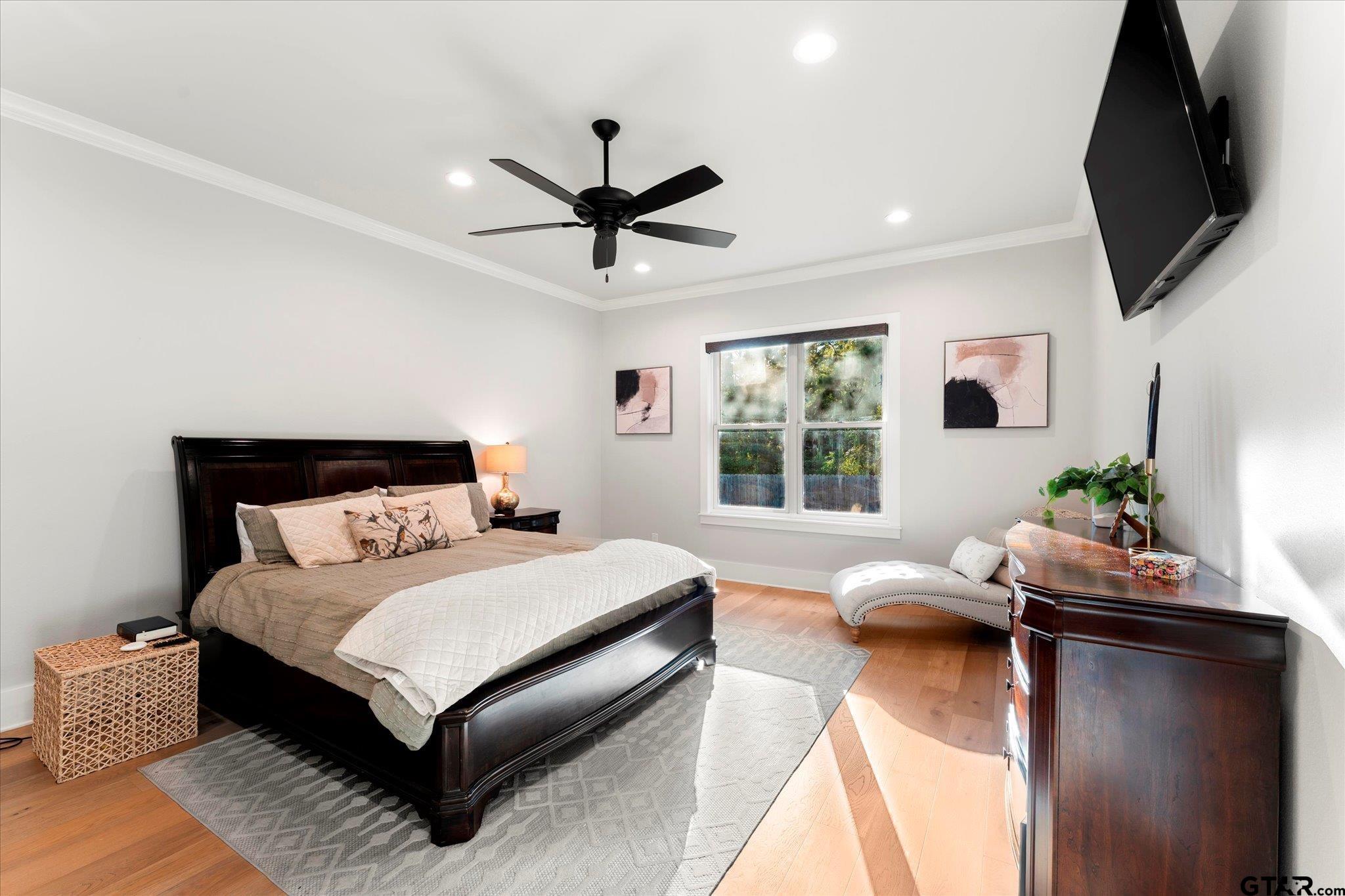 4301 Windrush Boulevard Longview, TX 75604 - Photo 15 of 36 a bedroom with a bed window and a flat screen tv