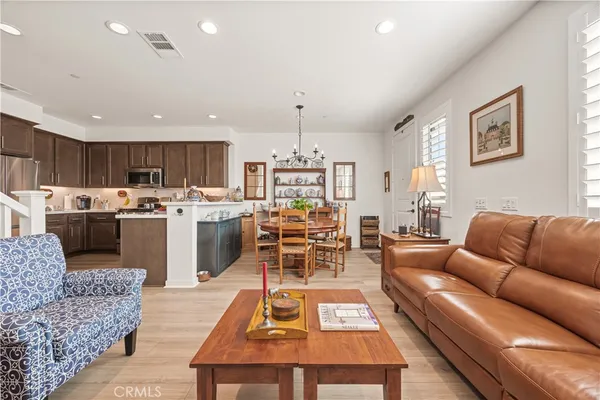 a living room with furniture and kitchen view