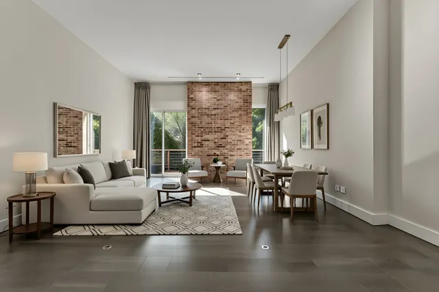 a living room with fireplace furniture and a large window