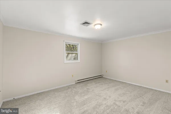 an empty room with a empty space and a window