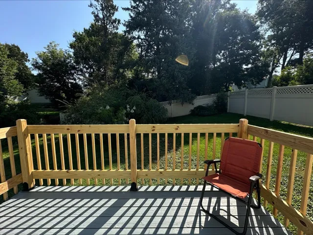 a view of a wooden deck and a yard