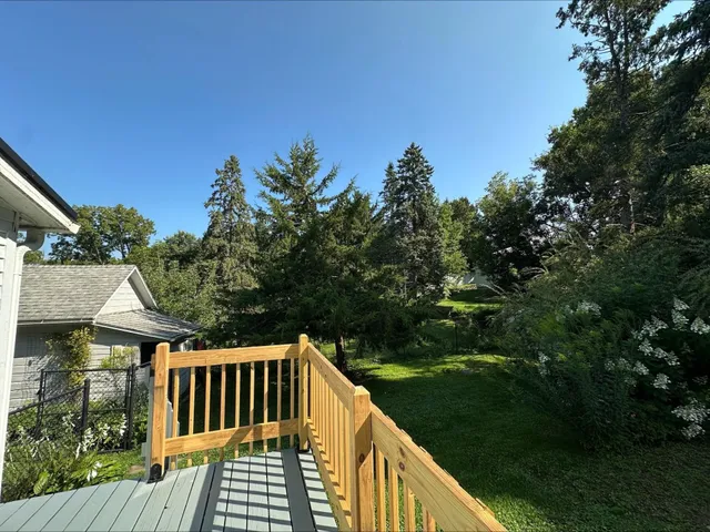 a backyard of a house with a yard and large trees