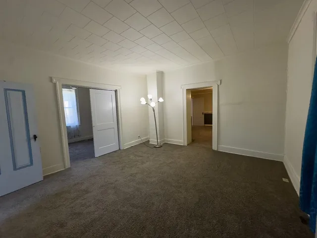 an empty room with closet and a bathroom