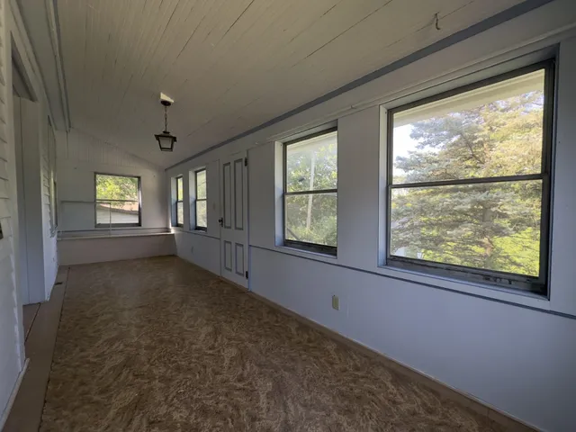 a view of an empty room with windows