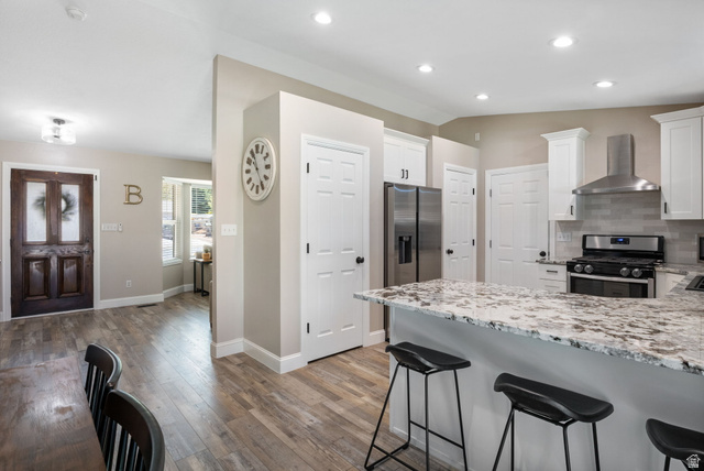 415 360 East Salem, UT 84653 - Photo 5 of 20 Kitchen featuring a large island with stone countertop, stainless steel appliances, white cabinetry, and recessed lighting