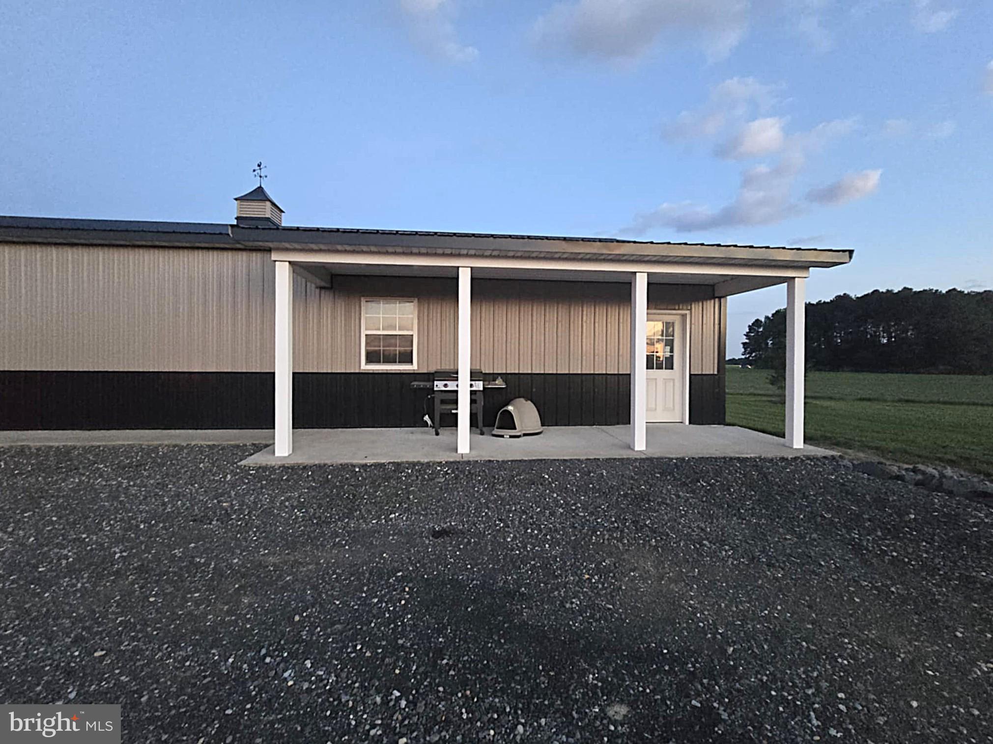 8019 Patten Road Denton, MD 21629 - Photo 8 of 11 a front view of a house with garden