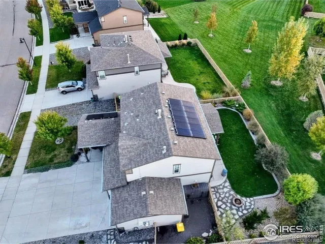 an aerial view of a house with a yard