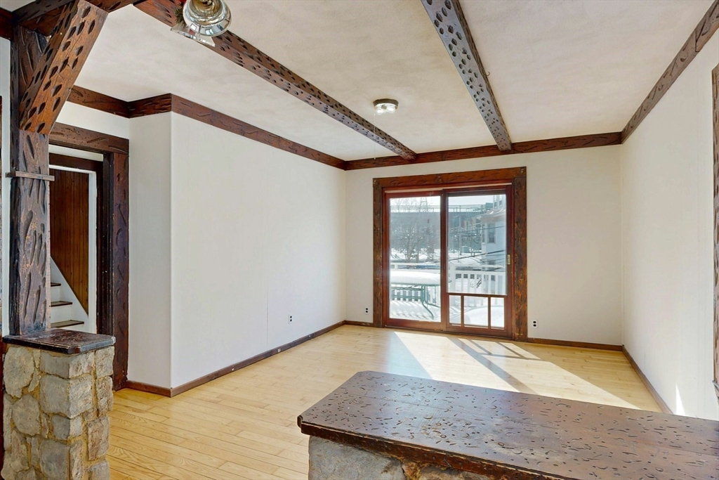 5 Alcott Street Boston, MA 02134 - Photo 11 of 36 a view of an empty room with wooden floor and a window