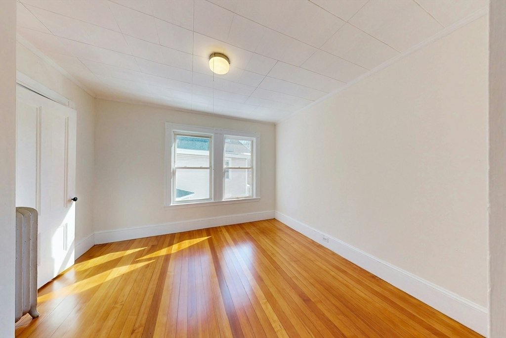 5 Alcott Street Boston, MA 02134 - Photo 18 of 36 a view of empty room with wooden floor and fan