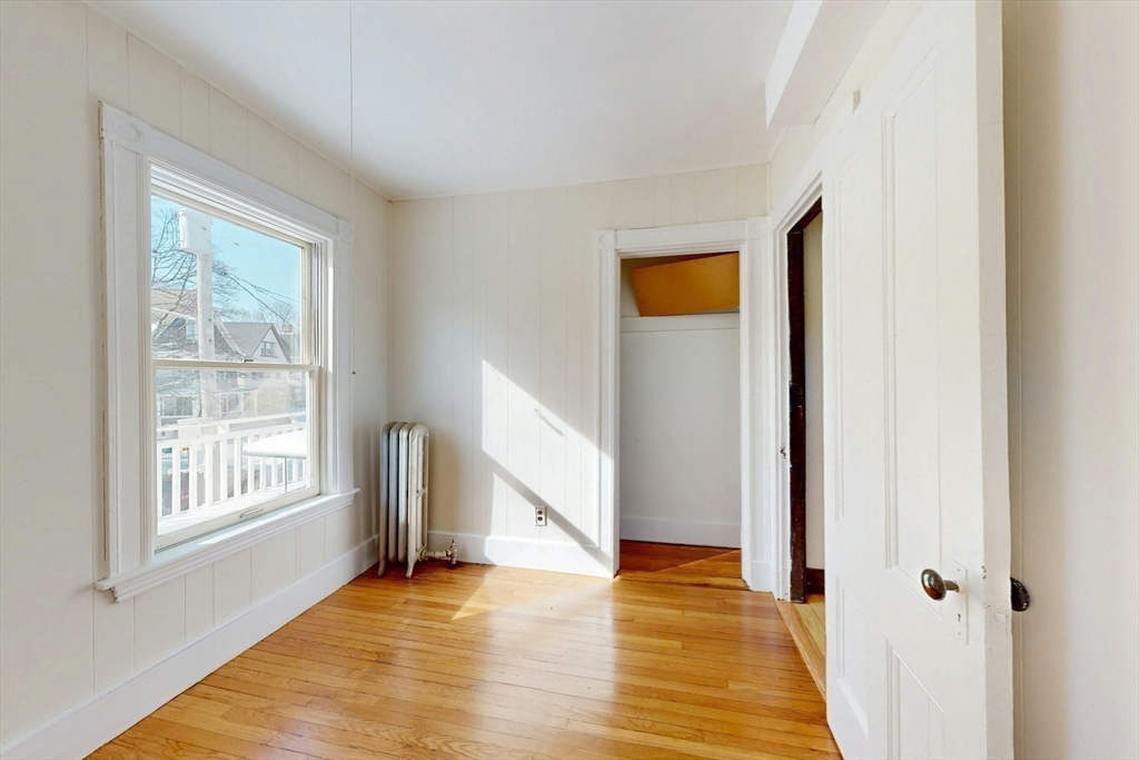 5 Alcott Street Boston, MA 02134 - Photo 20 of 36 a view of an empty room with wooden floor and a window