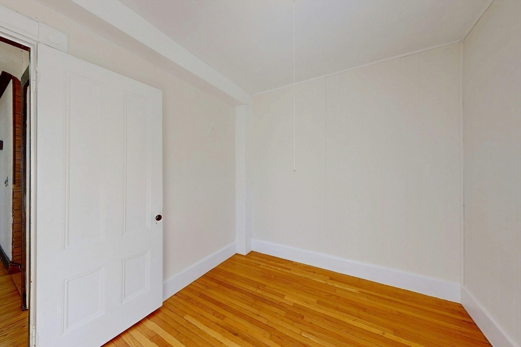 5 Alcott Street Boston, MA 02134 - Photo 21 of 36 a view of a room with wooden floor and a window