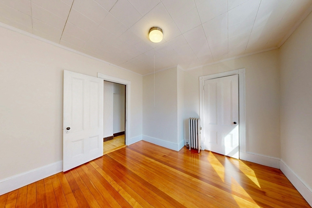 5 Alcott Street Boston, MA 02134 - Photo 22 of 36 a view of empty room with wooden floor