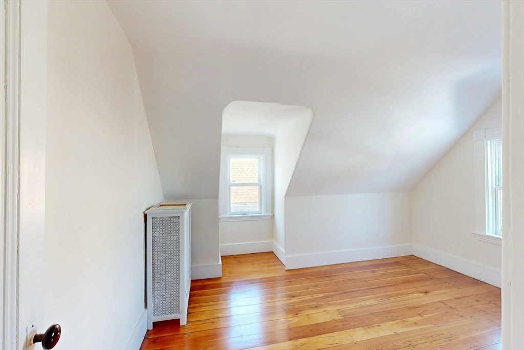5 Alcott Street Boston, MA 02134 - Photo 23 of 36 an empty room with wooden floor and windows
