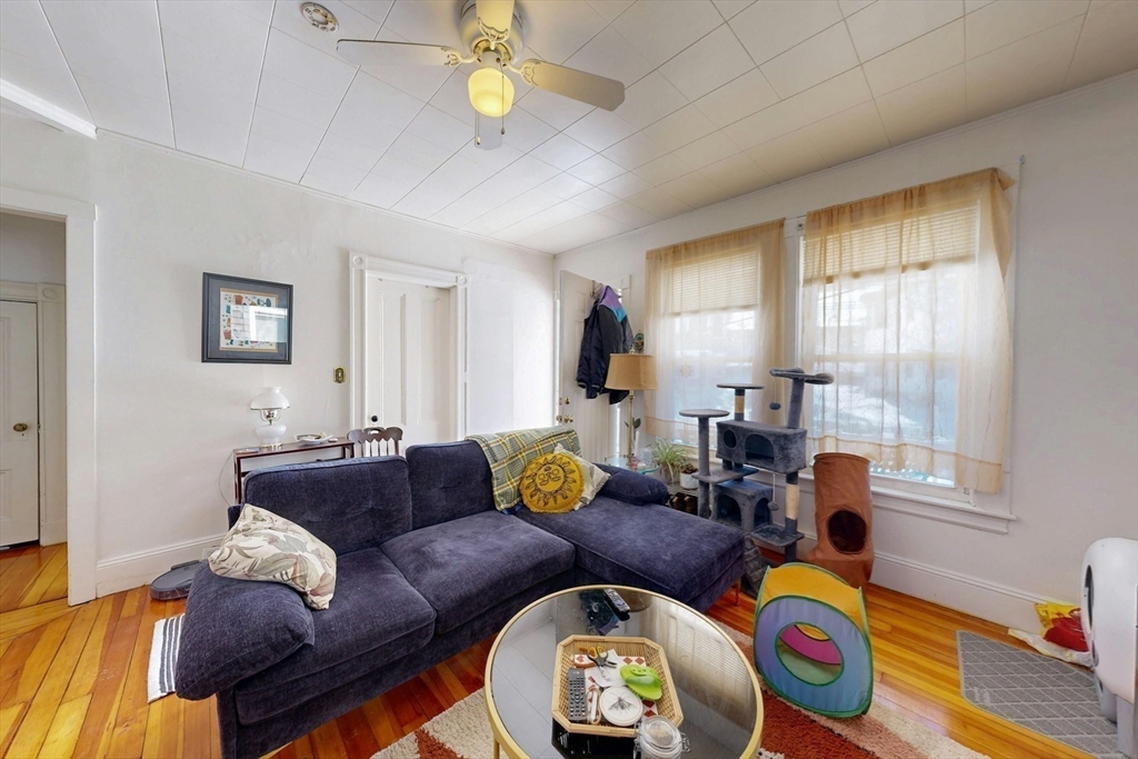 5 Alcott Street Boston, MA 02134 - Photo 25 of 36 a living room with furniture and a wooden floor
