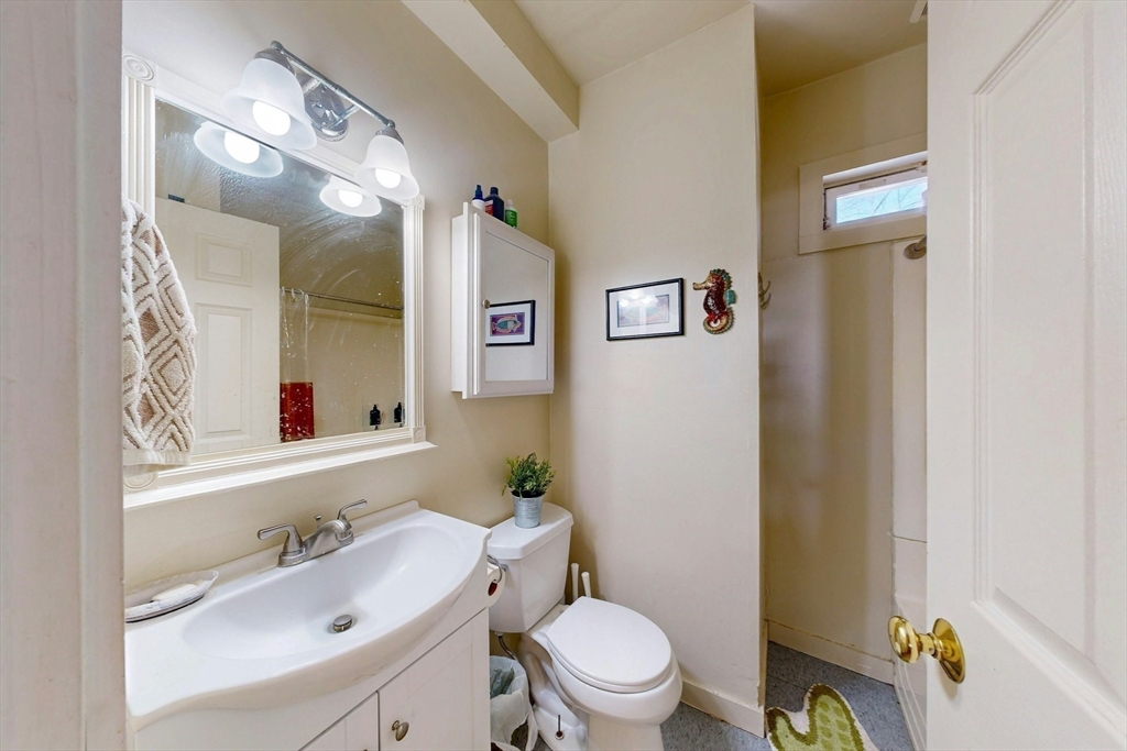 5 Alcott Street Boston, MA 02134 - Photo 31 of 36 a bathroom with a sink mirror vanity and toilet
