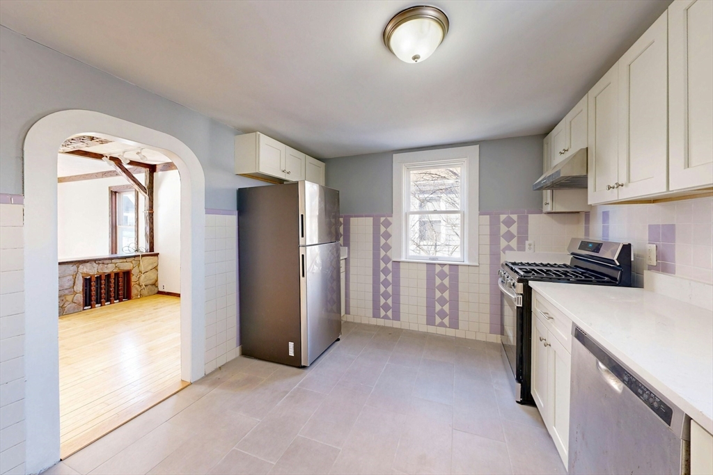 5 Alcott Street Boston, MA 02134 - Photo 5 of 36 a view of a kitchen with a sink refrigerator and window