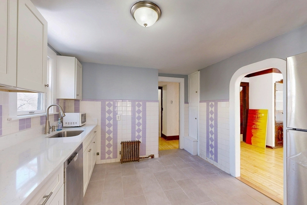 5 Alcott Street Boston, MA 02134 - Photo 6 of 36 a kitchen that has a sink and a stove