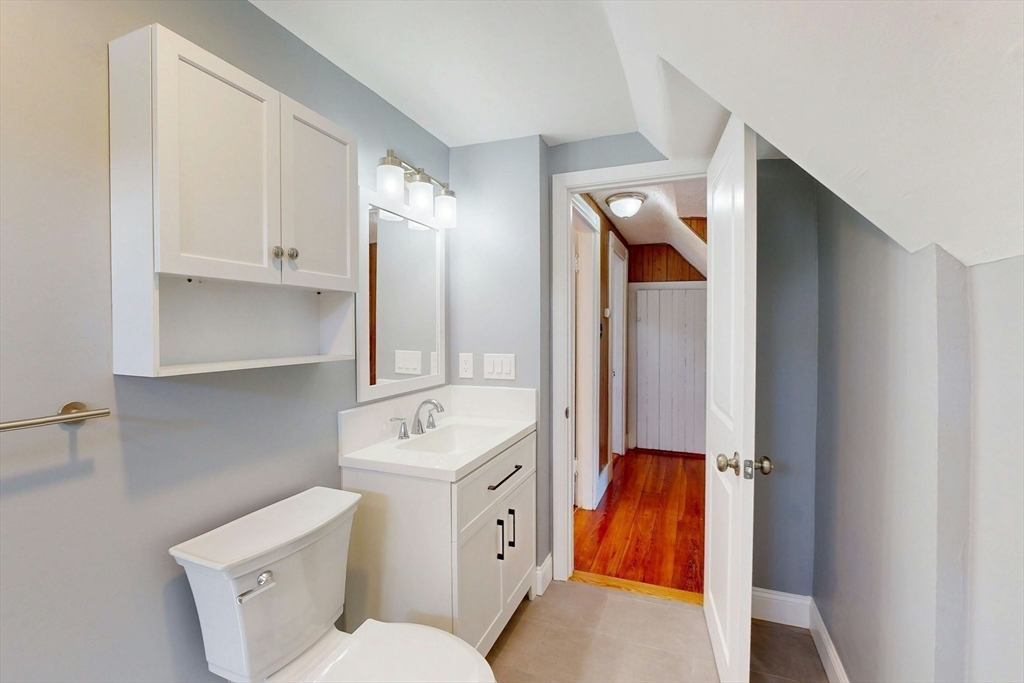 5 Alcott Street Boston, MA 02134 - Photo 8 of 36 a bathroom with a toilet sink and mirror