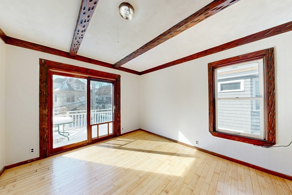 5 Alcott Street Boston, MA 02134 - Photo 10 of 36 a view of an empty room with wooden floor and a window