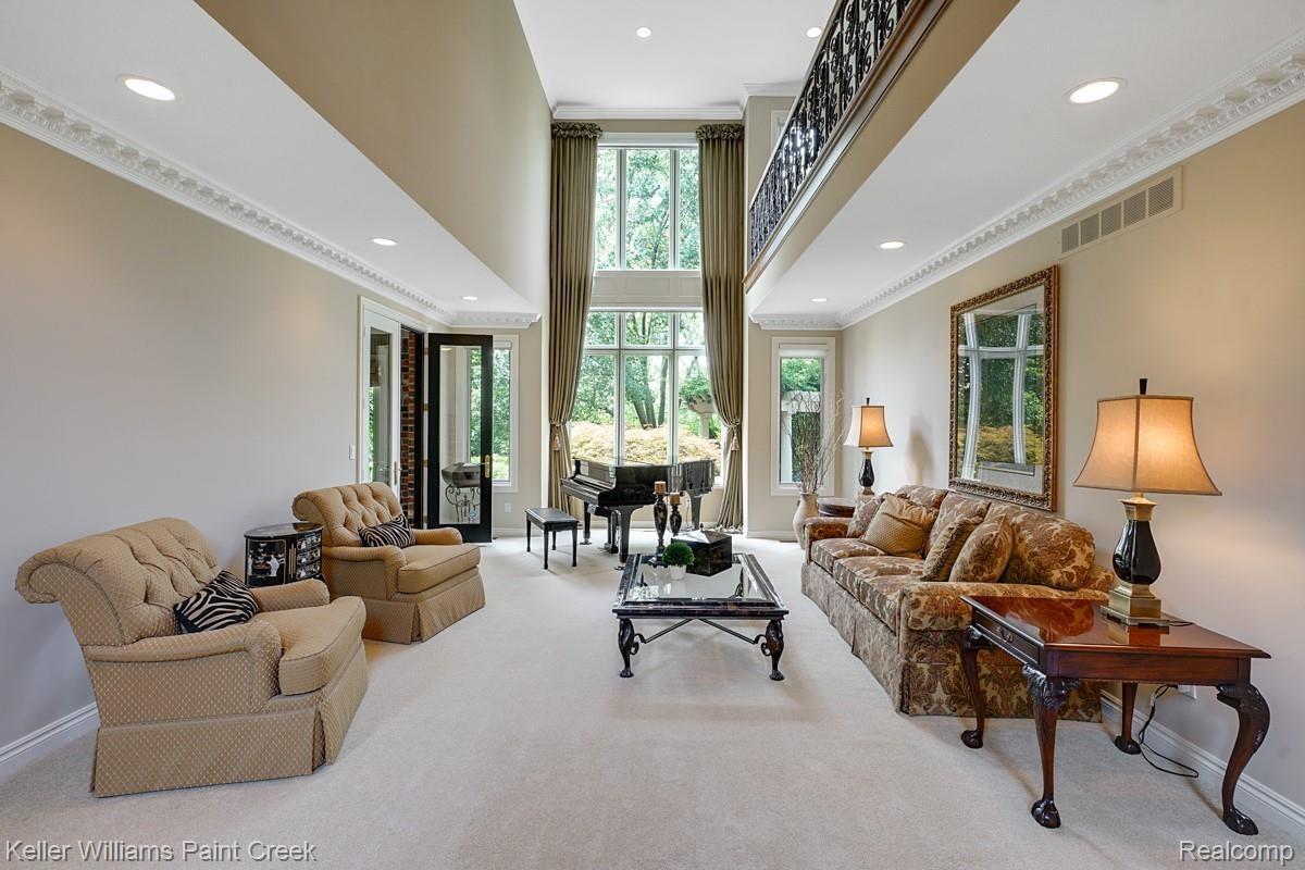 4902 Crestone Way Rochester, MI 48306 - Photo 18 of 70 A Two story formal Living Room with incredible custom dental moldings and a loft above with iron railings.