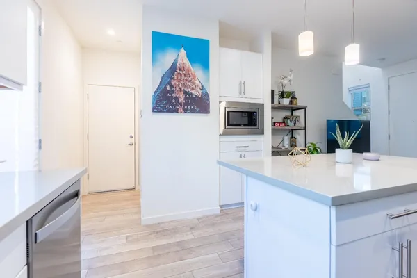 a kitchen with kitchen island a sink appliances and cabinets
