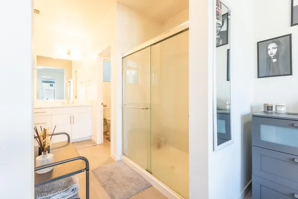 a bathroom with a granite countertop sink and a mirror