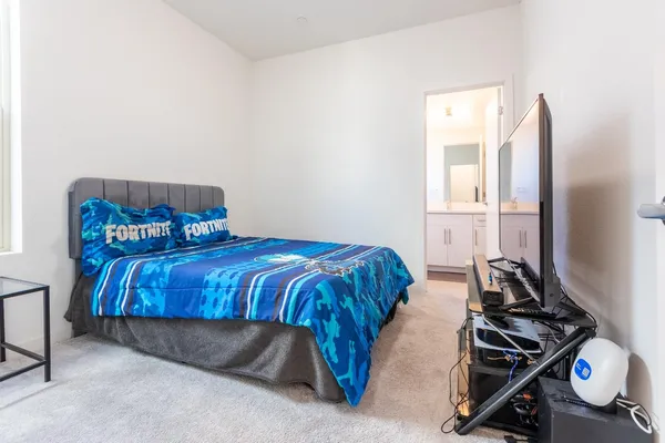 a bed sitting in a bedroom next to a window