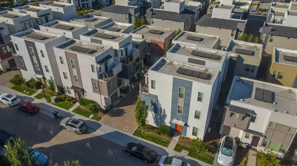 an aerial view of residential houses with outdoor space
