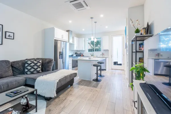 a living room with furniture and a dining table