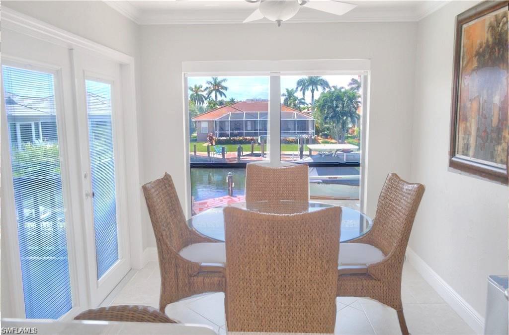 110 June Court Marco Island, FL 34145 - Photo 11 of 31 a view of a dining room with furniture large windows and wooden floor