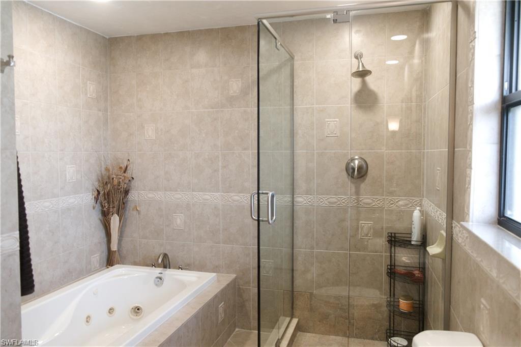 110 June Court Marco Island, FL 34145 - Photo 17 of 31 a bathroom with a bathtub and a shower