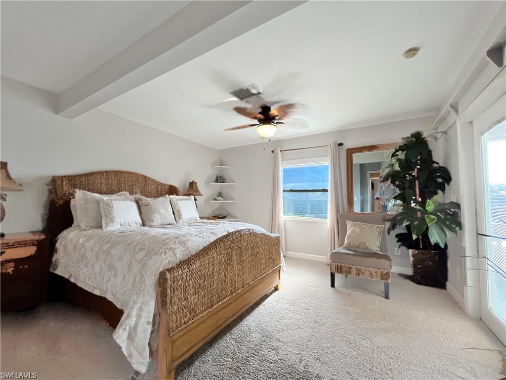 110 June Court Marco Island, FL 34145 - Photo 18 of 31 a bedroom with a bed and a chandelier