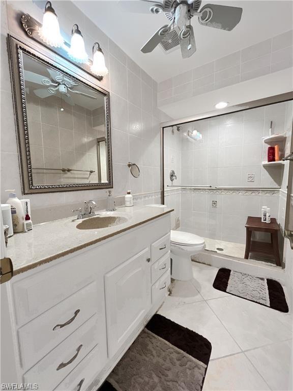 110 June Court Marco Island, FL 34145 - Photo 19 of 31 a bathroom with a double vanity sink mirror and toilet