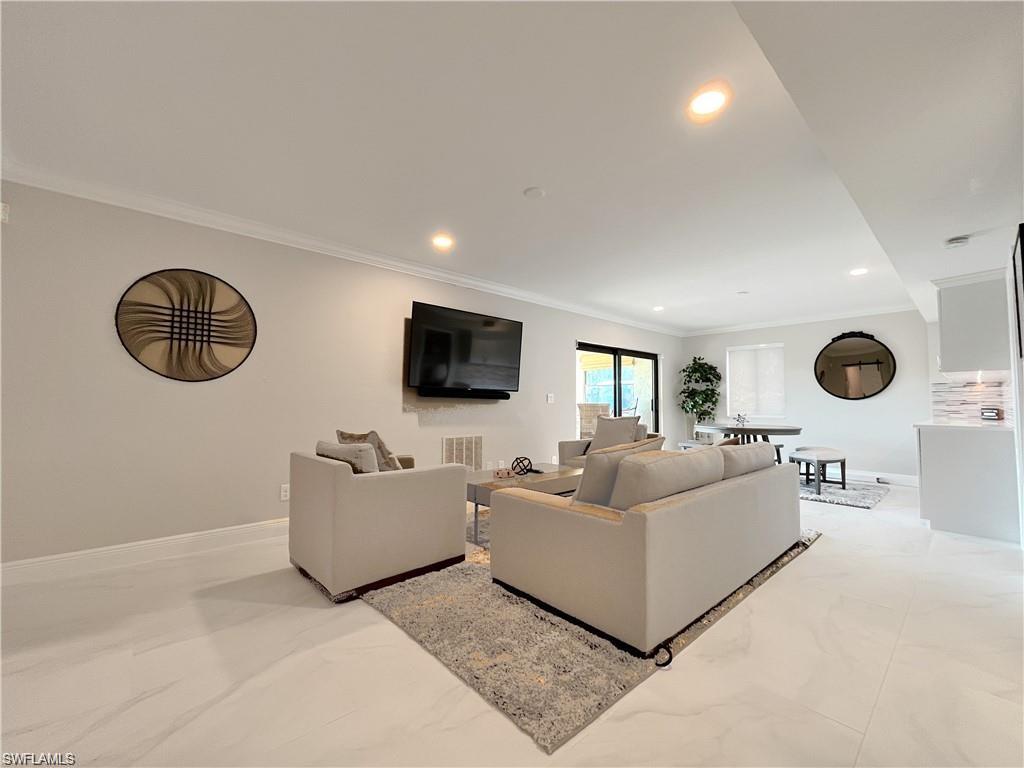 110 June Court Marco Island, FL 34145 - Photo 22 of 31 a living room with furniture and a flat screen tv