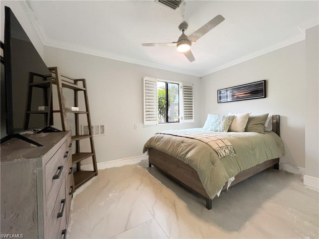 110 June Court Marco Island, FL 34145 - Photo 24 of 31 a bedroom with a bed and a flat tv screen on the dresser