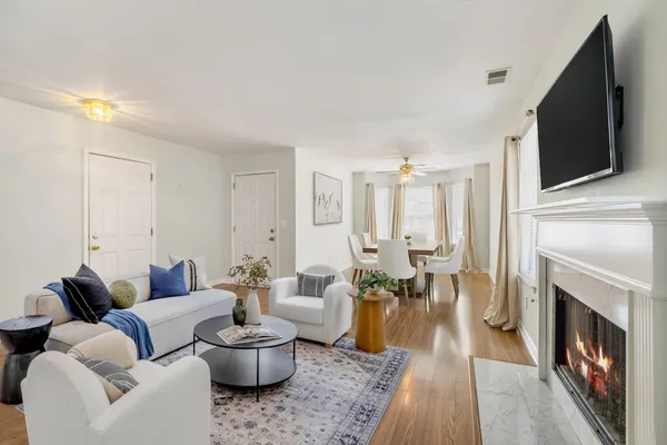 a living room with furniture fireplace and a flat screen tv
