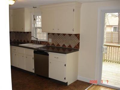 Undisclosed Address Harwich, MA 02645 - Photo 3 of 9 a kitchen with a sink and cabinets
