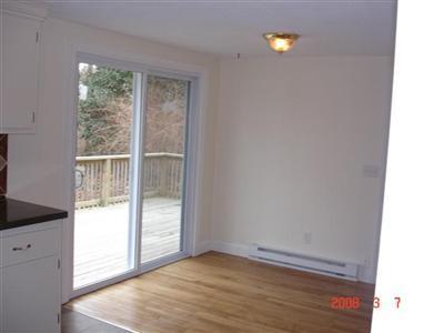 Undisclosed Address Harwich, MA 02645 - Photo 4 of 9 a view of an empty room with wooden floor and a window