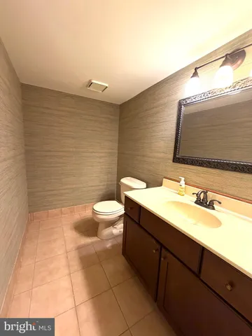 a bathroom with a sink a toilet and mirror