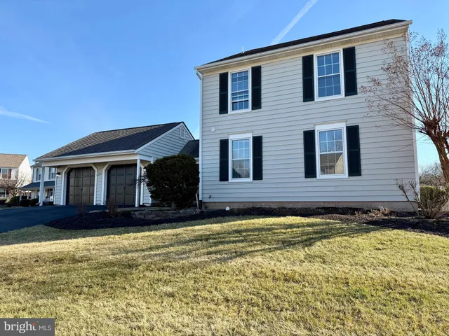 a view of a house with a large window and wooden fence