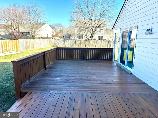 a view of balcony with wooden floor and fence