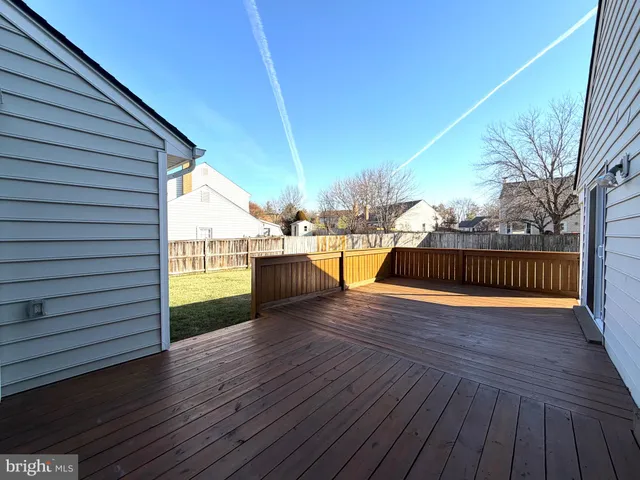 a view of a deck with wooden floor and fence