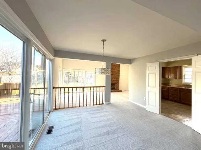 a view of a room with wooden floor and windows