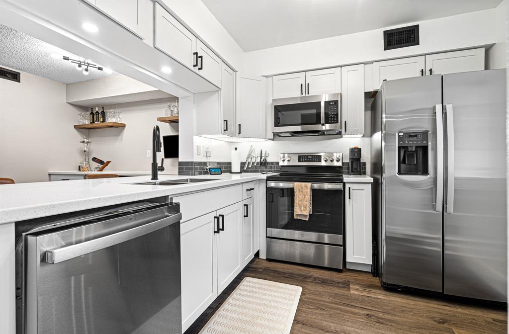 4620 West McNab Road, Unit B1 Pompano Beach, FL 33069 - Photo 11 of 36 a kitchen with stainless steel appliances a stove microwave and a refrigerator