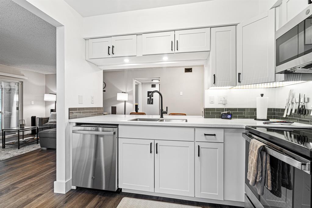 4620 West McNab Road, Unit B1 Pompano Beach, FL 33069 - Photo 12 of 36 a kitchen with cabinets and stainless steel appliances